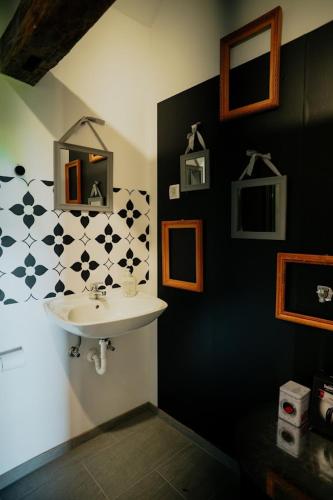 a bathroom with a sink and a black and white wall at Kuća za odmor Odvorci in Jakačina Mala
