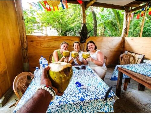 a group of three women sitting at a table at The Travel Tree Hostel in Sigiriya