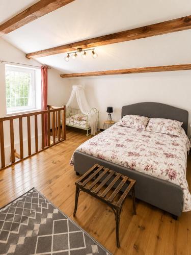 a bedroom with a bed and a wooden floor at Gîte Moulin de l'Anet in Goult