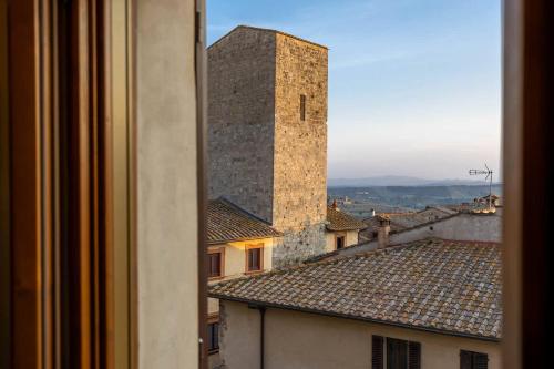 a view from a window of a building with a tower at Casa Costarella - San Gimignano in San Gimignano