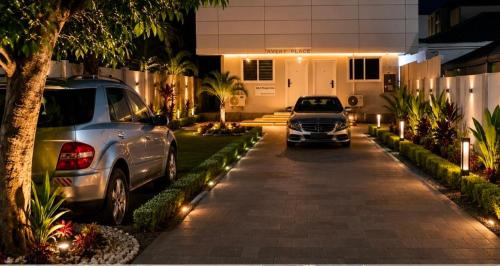 two cars parked in front of a building at night at SBJ Place East Legon in Accra