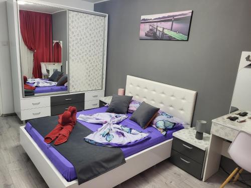 a bedroom with two beds and a mirror at Apartament Cristian Relax in Olimp