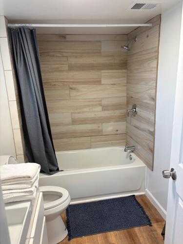 a bathroom with a white tub and a toilet at CRYStALZ pool studio kitchen DWNtWN stadiums arts in Phoenix