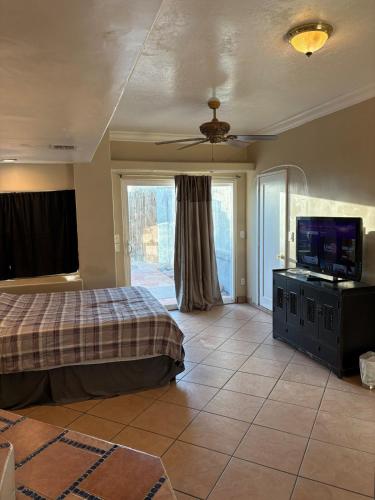 a bedroom with a bed and a flat screen tv at CRYStALZ pool studio kitchen DWNtWN stadiums arts in Phoenix