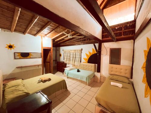 ein großes Zimmer mit zwei Betten und einer Couch in der Unterkunft La Posada in Máncora