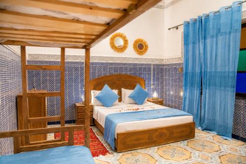 a bedroom with a bed and a ladder in a room at Dar Amireal Fez in Fez