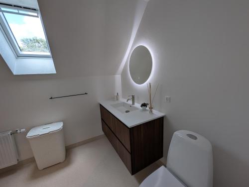 a white bathroom with a sink and a mirror at Kølkær B&B in Kølkær