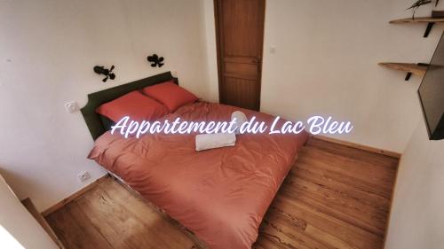 a small bedroom with a bed with a sign on it at La Maison de l'horloge in Bagnères-de-Bigorre