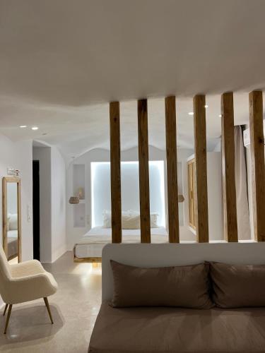 a living room with a bed and a couch at Pyrgianos Suites - Private Jacuzzi in Glinado Naxos