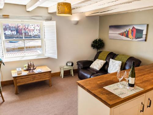 a living room with a couch and a table at Whitby Sea View Cottage Prime Historic Old Town Location in Whitby