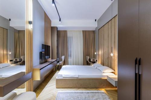a hotel room with two beds and a tv at Boulevard Residence Suite, 3 in Tashkent
