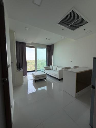 a white living room with a couch and a table at Del Mare Bangsaley condo in Bang Sare