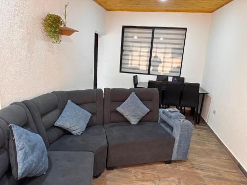 a living room with a couch and a table at Apartamentos Paipa Boyacá "Las Quintas" Pisos 2 y 3 in Paipa