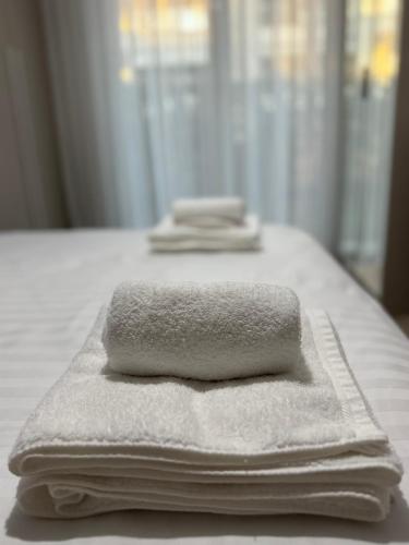 a pile of towels sitting on top of a table at San Pietro Premium Meliá Garden Apartment in Lalzit Bay