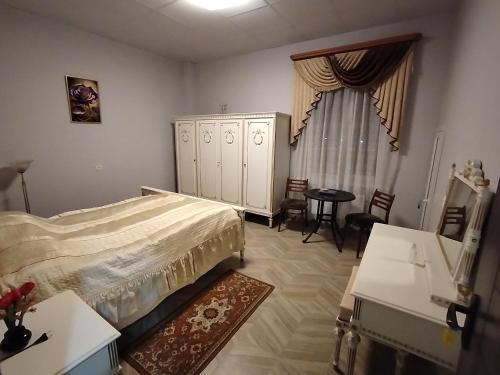 a bedroom with a bed and a dresser and a table at Tsaghkadzor Family Rest in Tsaghkadzor