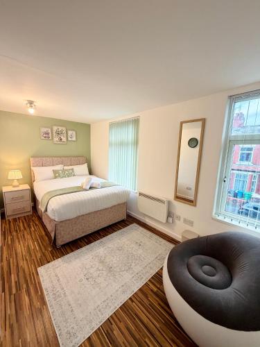 a bedroom with a bed and a large window at Brit Rooms Manchester in Manchester