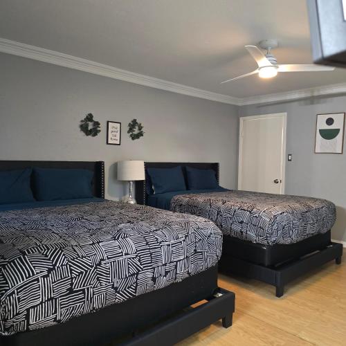 a bedroom with two beds and a ceiling fan at HoustonGem Private Pool & Hot Tub 20 Min to DT in Houston