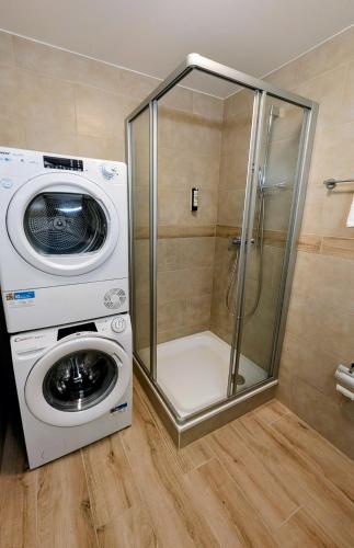a washing machine and a washer in a bathroom at Chillon lake view by MK in Montreux