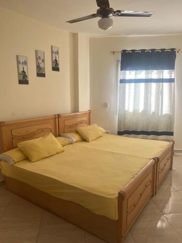 a large bed in a bedroom with a ceiling fan at White Bay Ras Sedr وايت باي راس سدر in Ras Sedr