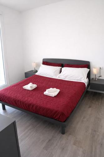a bedroom with a bed with two towels on it at Civico27-modern apartment in Sondrio in Sondrio