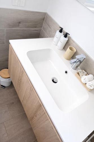 a bathroom with a white sink and a toilet at Civico27-modern apartment in Sondrio in Sondrio