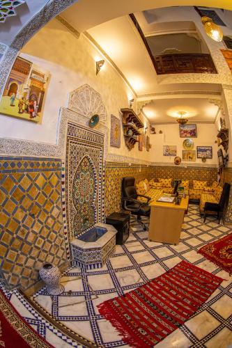 a living room with a tile floor and a room with a couch at Dar Amireal Fez in Fez
