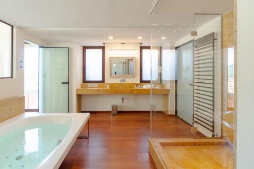 a large bathroom with a tub and a sink at Luxury Como Lake - Luxury Villa with Infinity Pool in Blevio