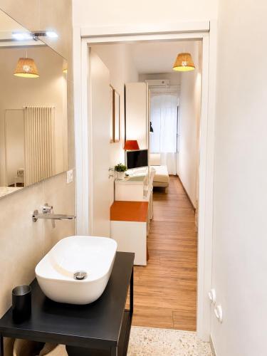 a bathroom with a white sink and a mirror at Matinee Rooms in Mattinata
