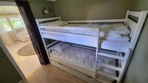 a bedroom with two bunk beds in a room at Semesterbostad Viksberg in Avesta