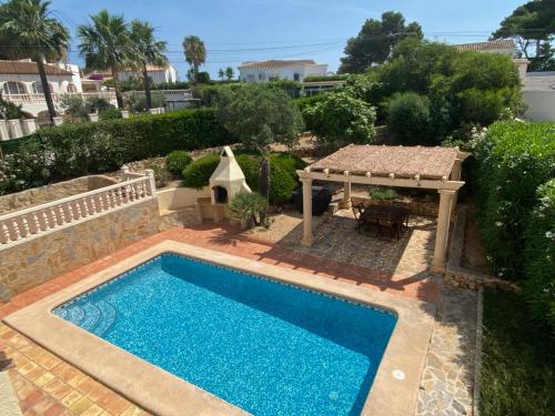 a swimming pool in a yard with a gazebo at Casa Luis - Javea - Spanien in Jávea