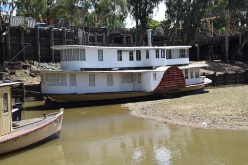 two boats are docked on the water in a river at Big River Motel in Echuca