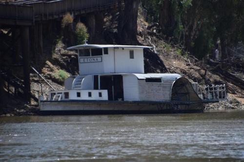 a small boat on the water under a bridge at Big River Motel in Echuca
