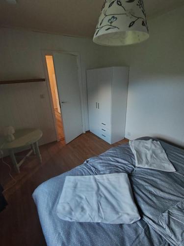 a bedroom with a bed with two sheets on it at U Maxa , całe mieszkanie na wyłączność in Sogndal