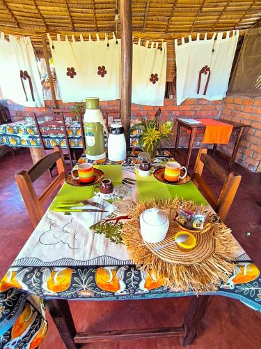 a table with plates of food on top of it at Le Relais de Djangoa in Djangoa