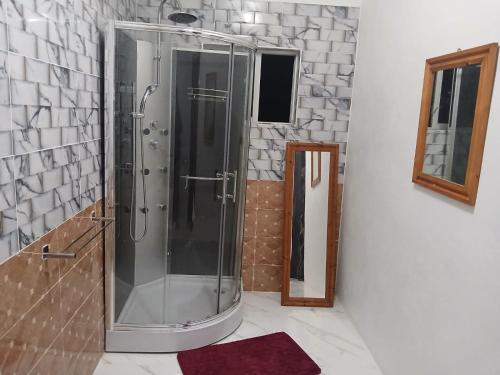 a shower with a glass door in a bathroom at Skyview Palace in Montpelier