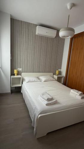 a bedroom with a large white bed in it at Apartamentos FELIP 2 in Burriana