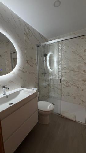 a bathroom with a shower and a toilet and a sink at Apartamentos FELIP 2 in Burriana