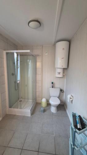 a bathroom with a glass shower and a toilet at Amber coast - domek nr 5 in Jantar