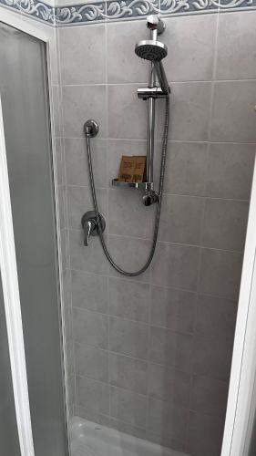 a shower with a shower head and a shower at nido delle farfalle in Stazione di Chiusi