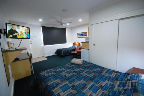 a hotel room with a bed and a flat screen tv at Comfort Inn & Suites Augusta Westside in Port Augusta