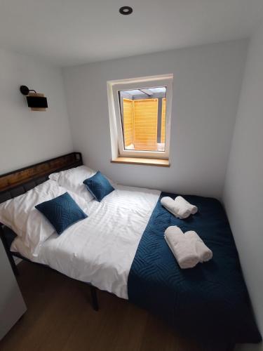 a bedroom with two beds and a window at Domki u Ewy in Spychowo