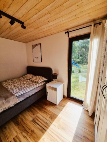 a bedroom with a bed and a large window at Sasinko Mini in Sasino