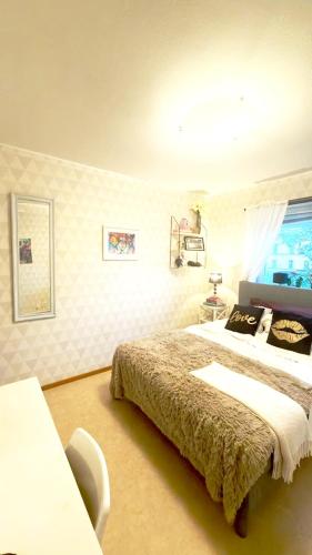 a bedroom with a bed and a window in it at The Creative Studio Apartment in Piteå