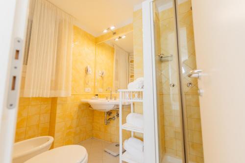 a bathroom with a sink and a toilet and a shower at Il San Francesco Charming Hotel in Sabaudia