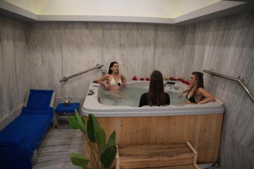 three women in a bathtub in a room at Marina Sharm Hotel in Sharm El Sheikh