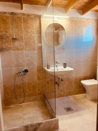 a bathroom with a shower and a sink and a toilet at Divine Island Escape in Kini