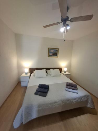 a bedroom with a large white bed with two pillows at Apartman Terrazza in Sumartin