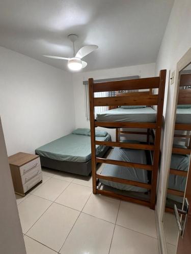 a room with a bunk bed and a bunk bed gmaxwell gmaxwell gmaxwell gmaxwell at Lindo Apartamento na Guilhermina PG in Praia Grande