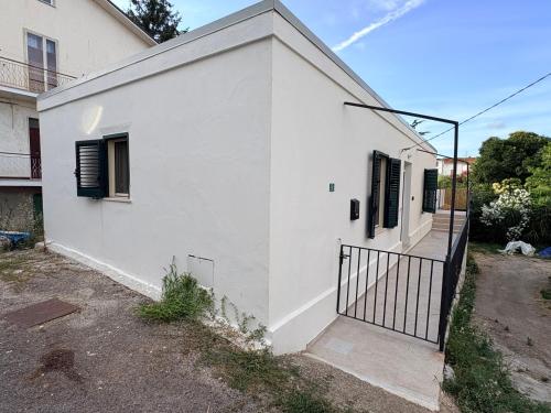 a white house with a black gate in front of it at La Terrazza in Ortona