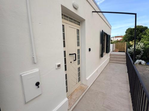 a white building with a door and a walkway at La Terrazza in Ortona